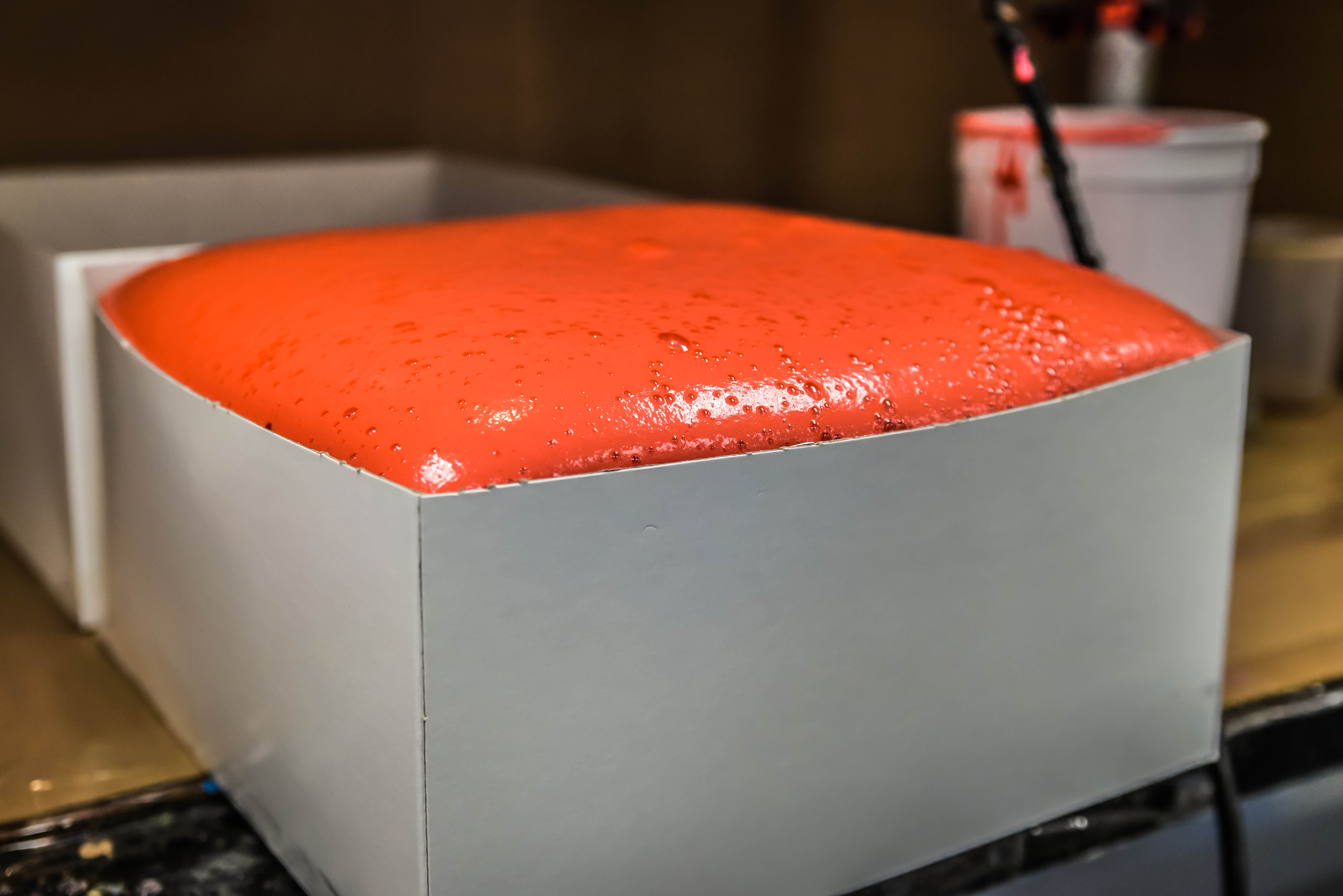 Bright orange/red expanding foam.